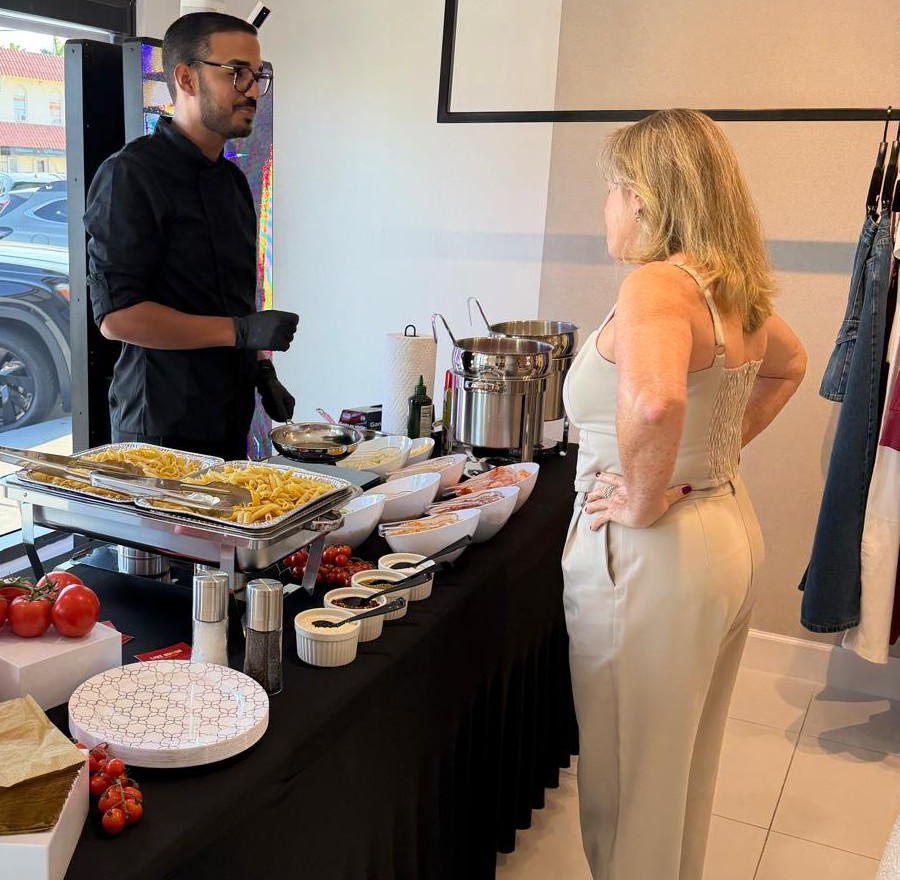Chef serving pasta to a guest